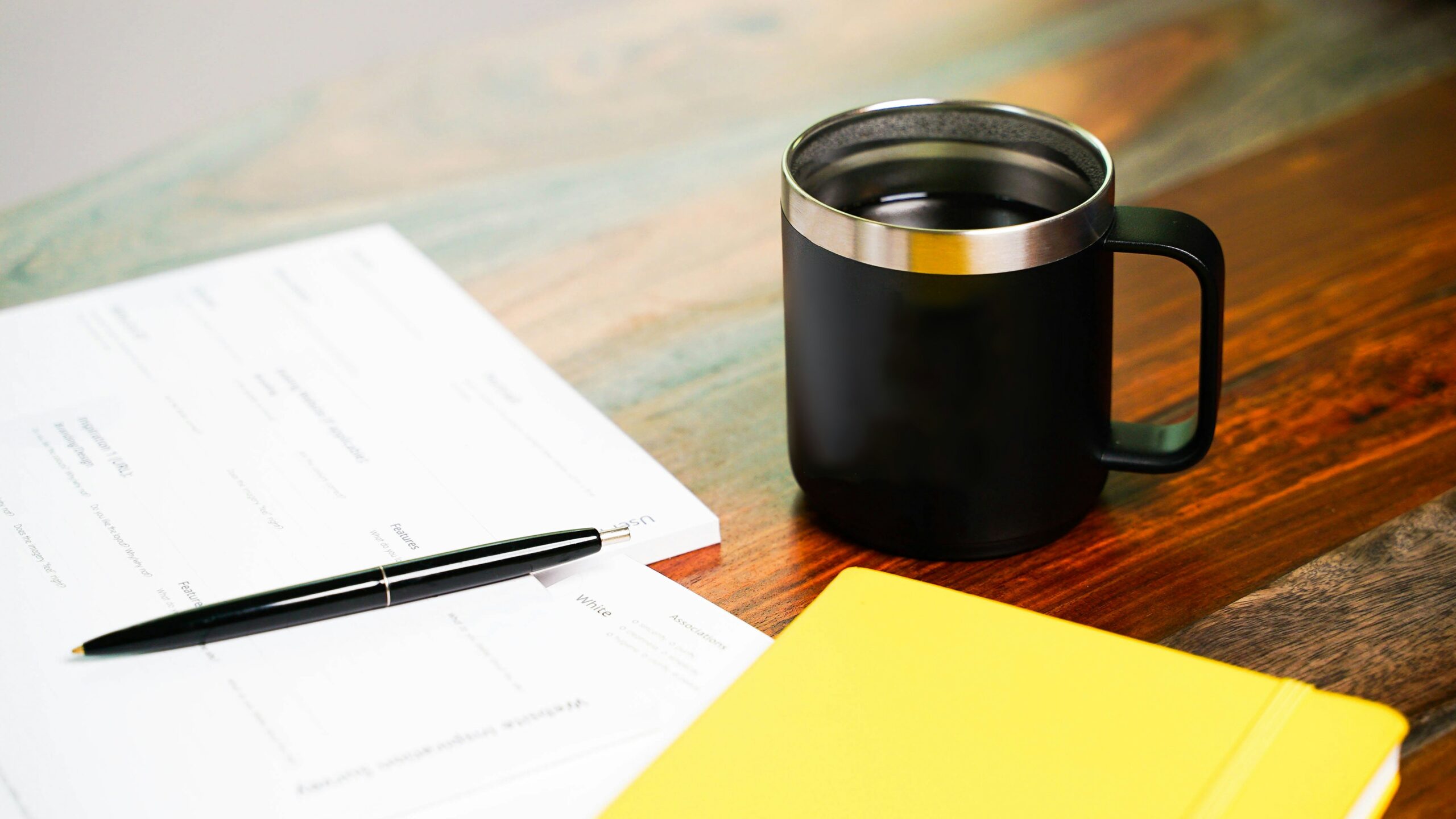 Out of focus paper with a mug on a table